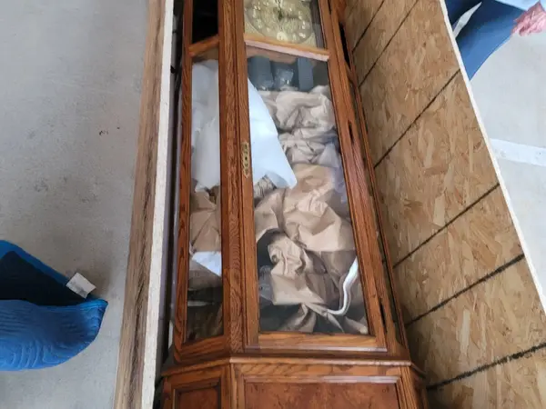 Antique grandfather clock packed and secured inside a custom plywood crate