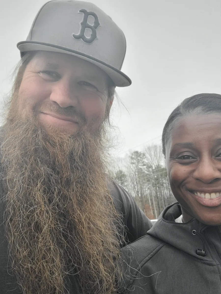 Two members of the Top-Tiered Technicians family team outdoors at a job site